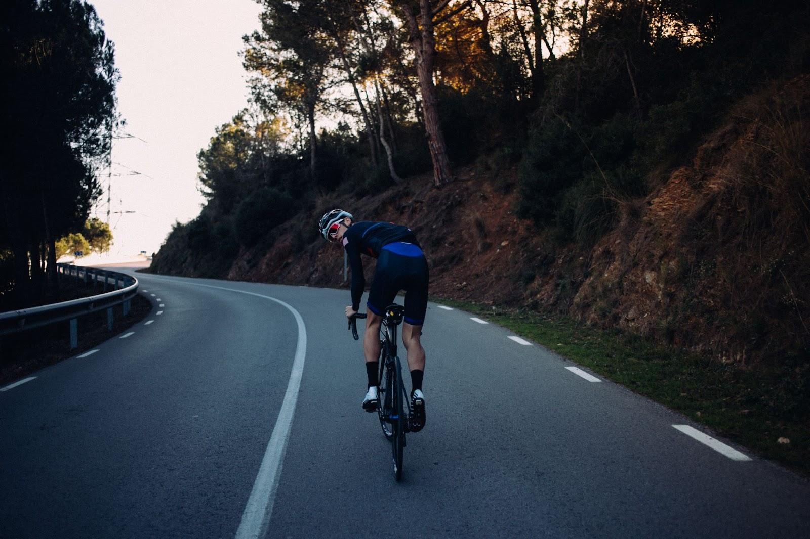 Road cyclist climbing on a quiet mountain road
