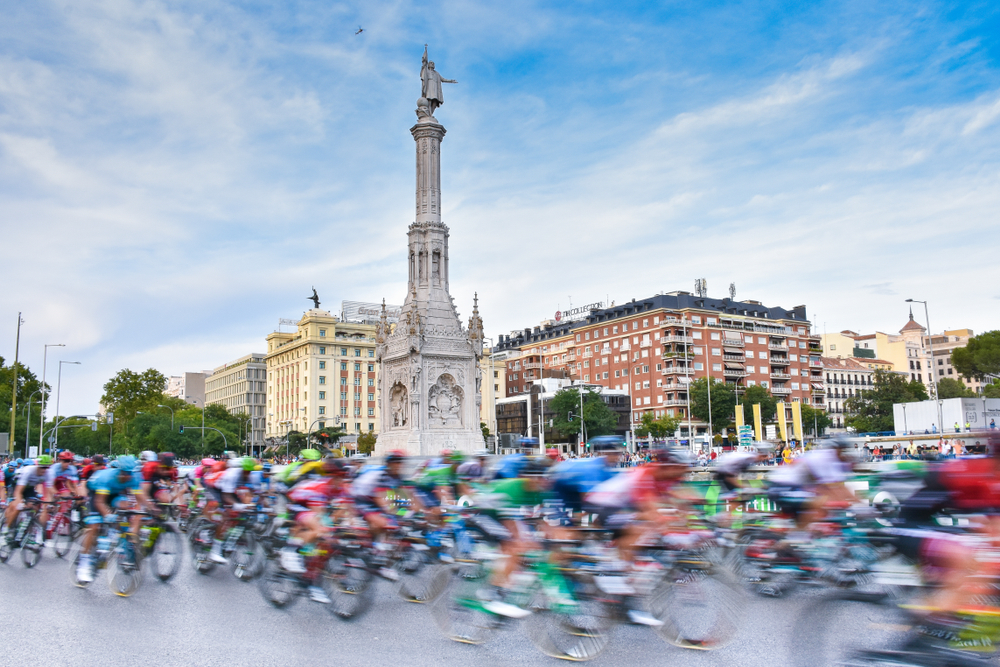 The cyclists peloton go through the colon plaza in madrid.