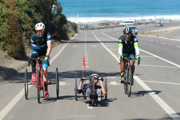 Three cyclists with physical challenges riding together