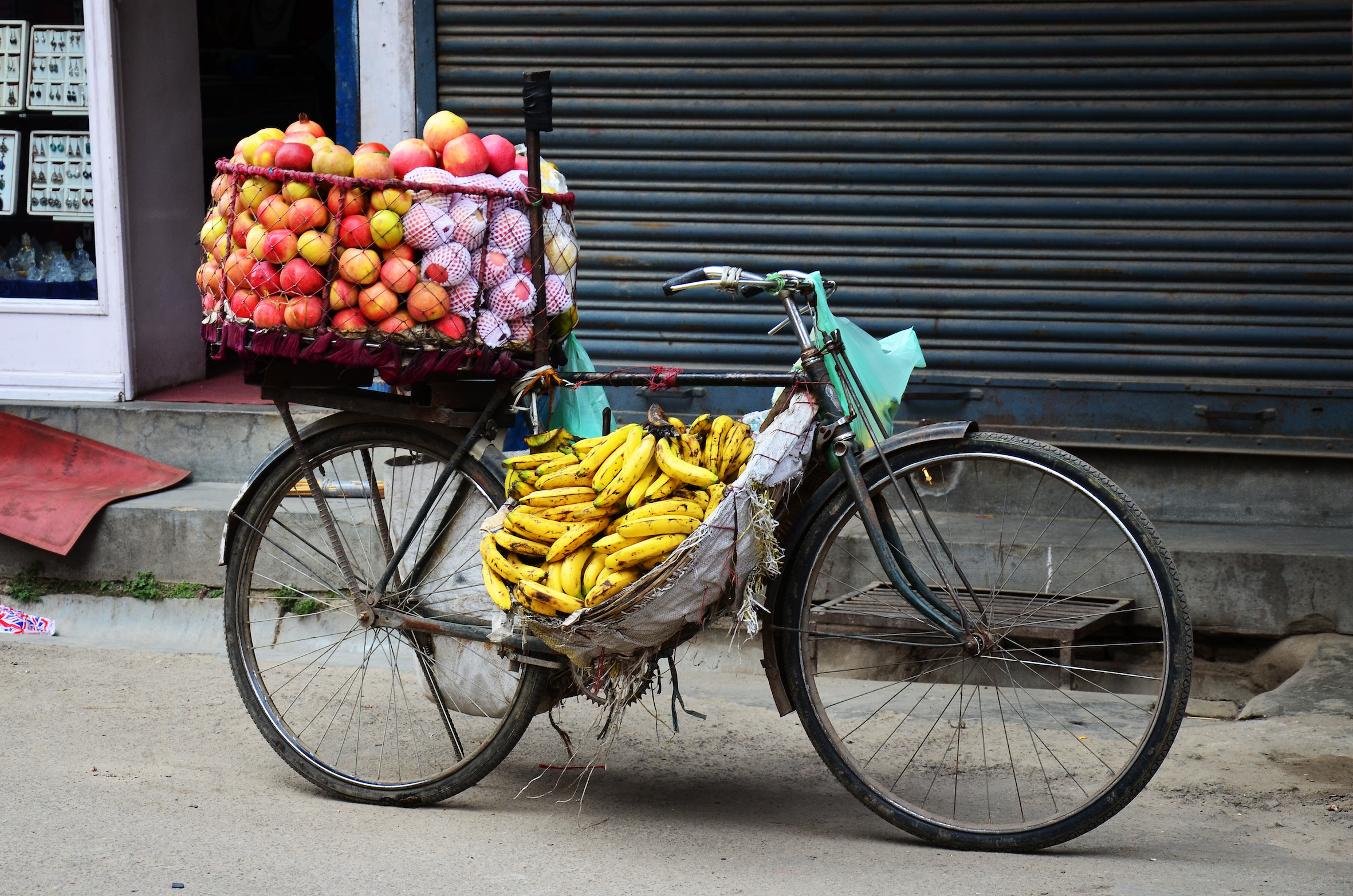 old street bicycle loaded with apples and bananas